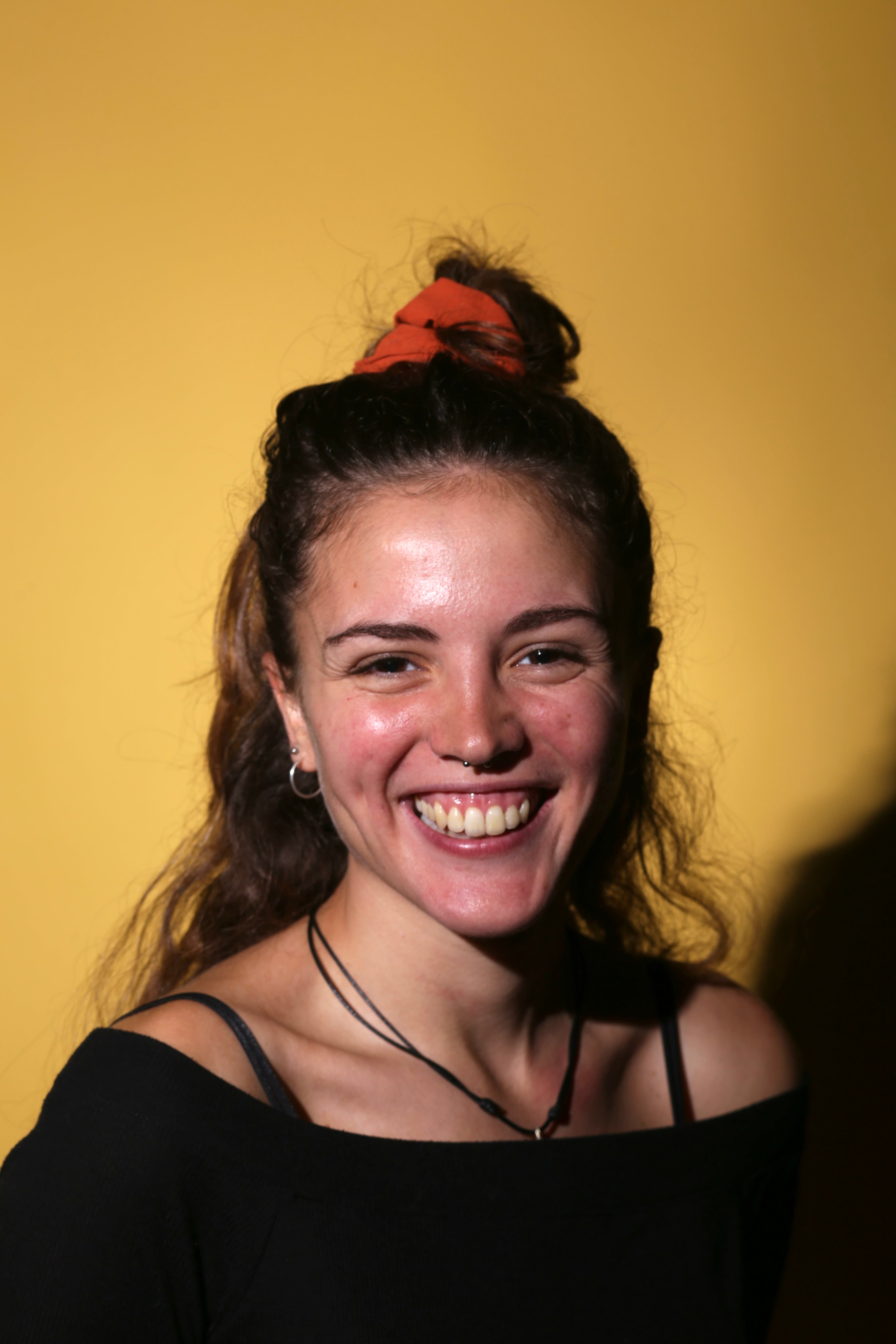 Smiling woman against yellow background