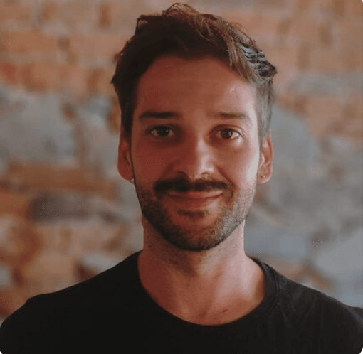 Portrait of a man in front of a brick wall