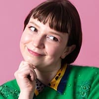 Portrait of a smiling woman against pink background
