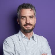 Portrait of a man against a purple background