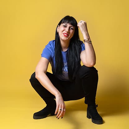 Person in squat with yellow background