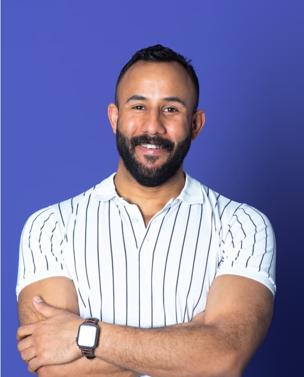 Man with arms crossed smiling