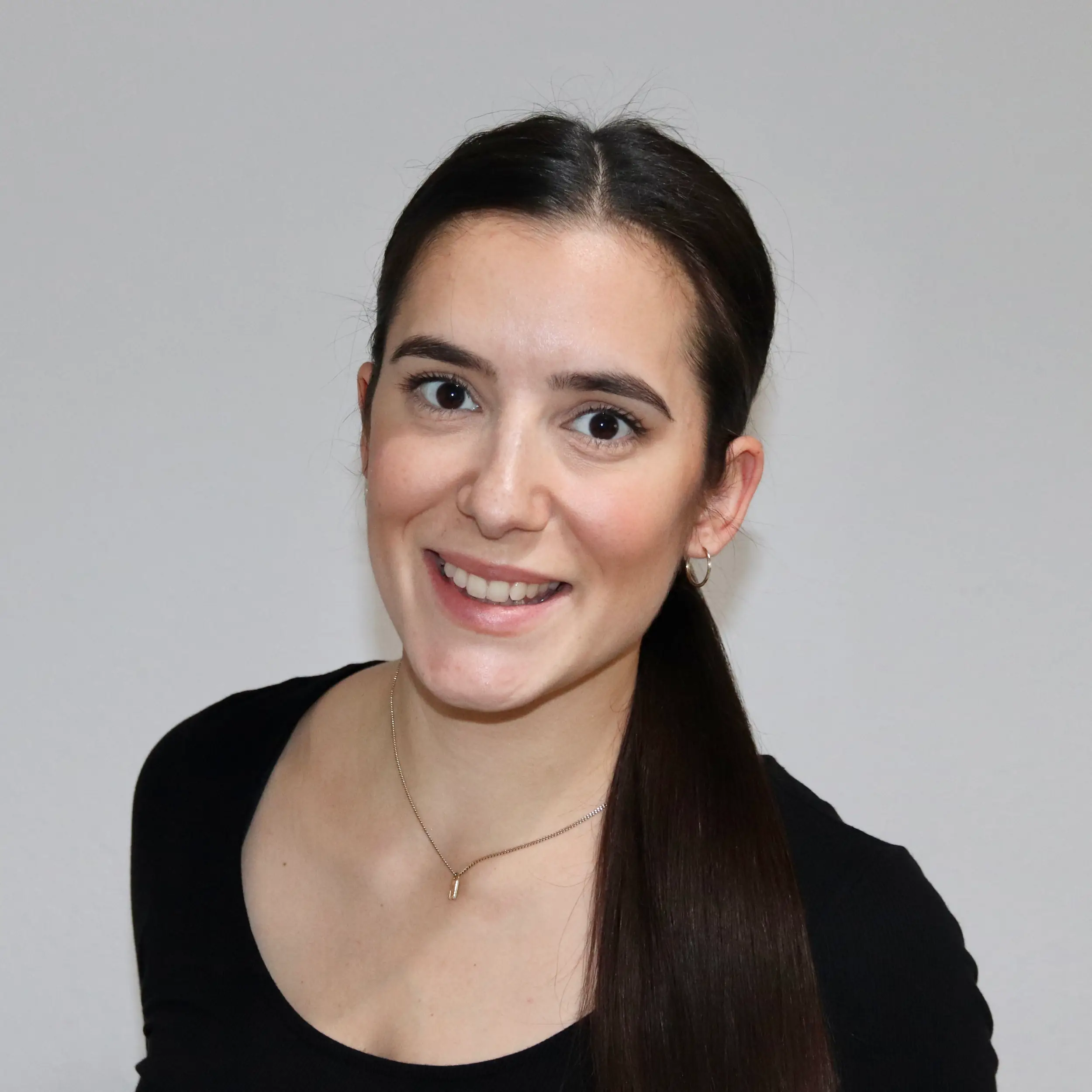 Portrait of a smiling young woman with dark hair.