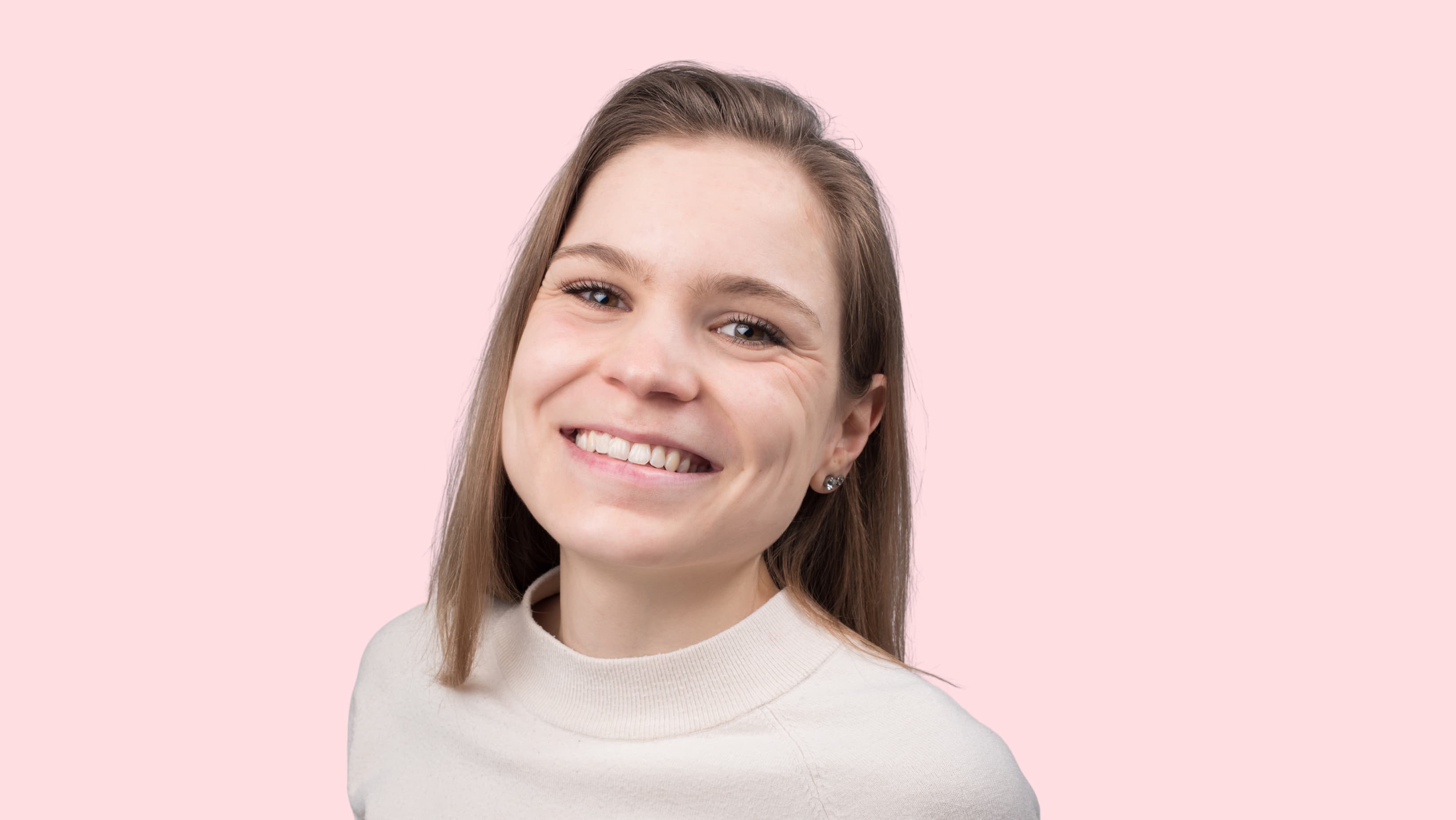 Smiling woman against pink background