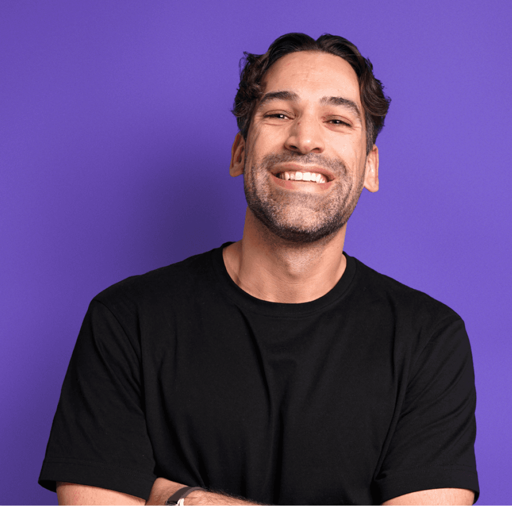 Smiling man against purple background