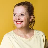 Portrait of a smiling woman against yellow background